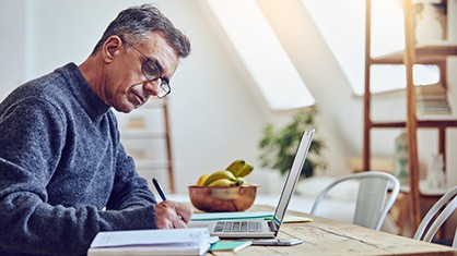 Man writing a press release at a desk