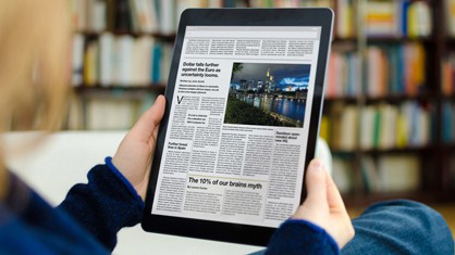 Woman using a tablet to look at a press release