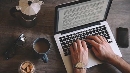 Man writing a press release on his laptop