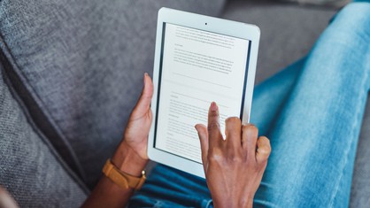 Person using a tablet to get a press release sample