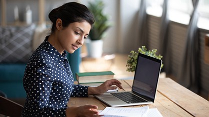 Woman creating a press release template with her laptop